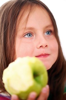Portrait of little girl eating green apple