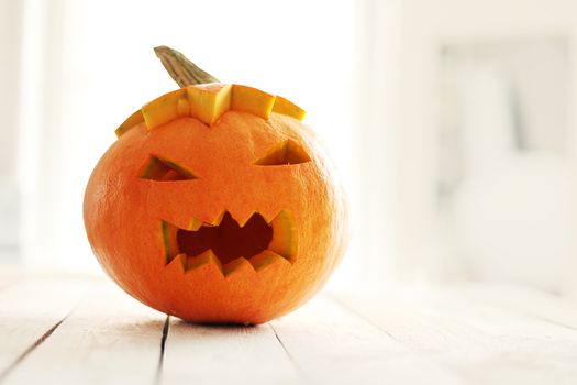 Halloween pumpkin on a white wooden surface