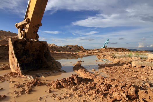 excavator loader machine during earthmoving works outdoors at construction site