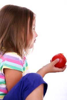 Close up of Little girl eat tomato