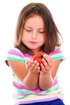 Little girl with tomato over white background