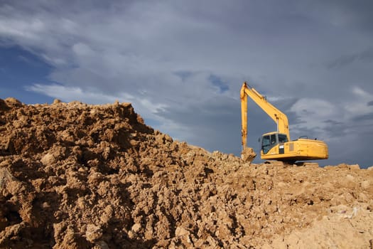 excavator loader machine during earthmoving works outdoors at construction site