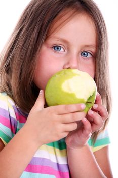 Portrait of little girl eating green apple