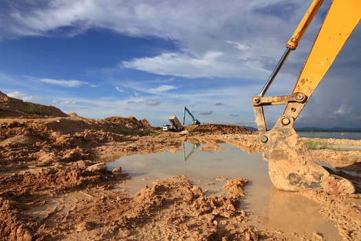 excavator loader machine during earthmoving works outdoors at construction site