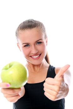 Beautiful fitness girl with green apple in hand over white background