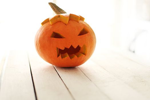 Halloween pumpkin on a white wooden surface