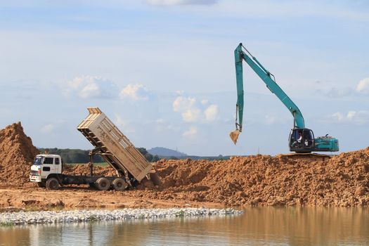 Excavator located by a river and ready for work