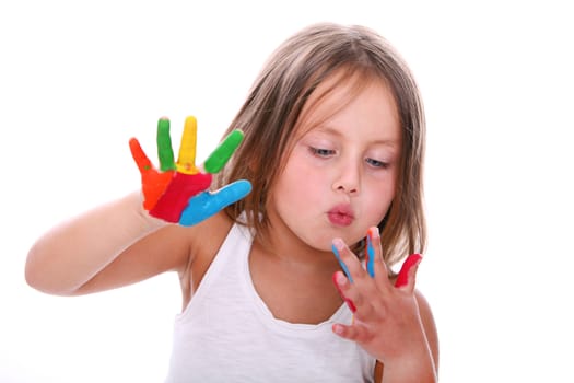 Portrait of little girl with painted hands blowing on her fingers isolated on white