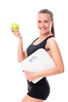 Happy woman with scales and green apple over white background