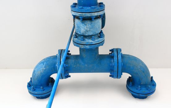 blue pipe line with blue valve on  wall