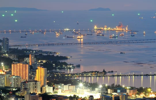 Port warehouse with cargoes and containers at night