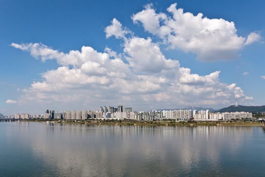 Beautiful panoramic view of a city on a river under a cloudy sky