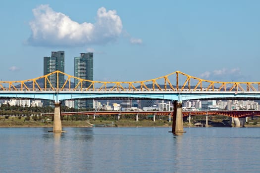 A bridge with a subway train over river in sunny afternoon