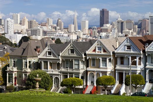 Painted Ladies with San Francisco skyline in the background as seen from Alamo Square.