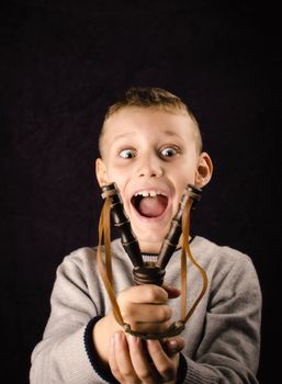 Child who just received a slingshot on his birthday