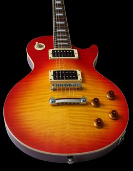 Closeup of electric guitar in cherry sunburst colour isolated on black background.