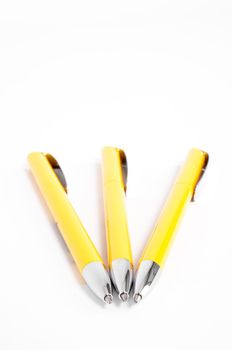 Yellow pen closeup on the white background