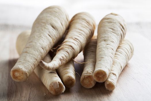Fresh raw parsnips on a cutting board.