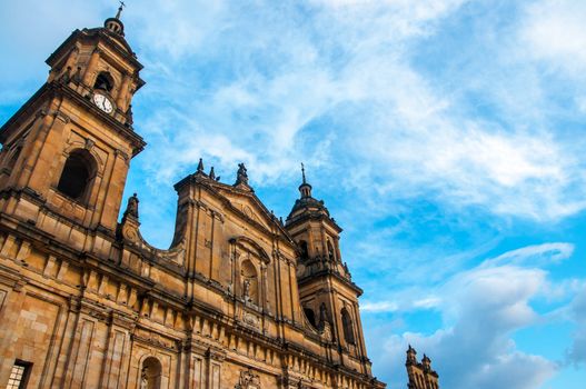 The front of the cathedral in Bogota, Colombia with a blue sky behind it.