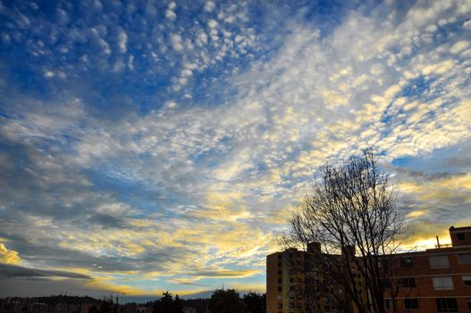 A dramatic sky in an urban setting with apartments in the foreground.