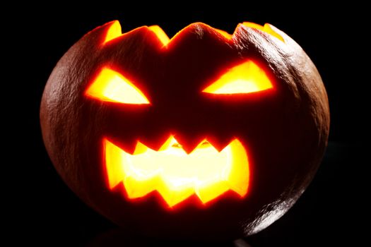 Illuminated halloween pumpkin on a black background