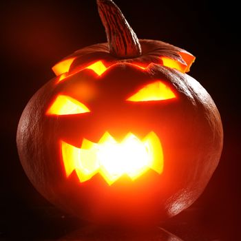 Illuminated halloween pumpkin on a black background