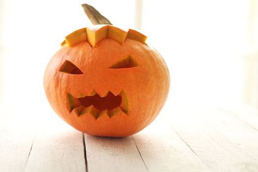 Halloween pumpkin on a white wooden surface