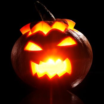 Illuminated halloween pumpkin on a black background