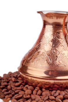 Copper coffee pot and coffee beans around