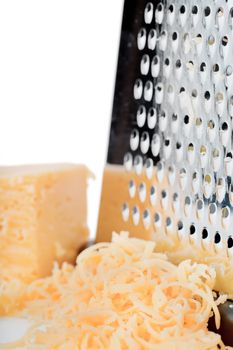 Closeup view of grater and grated cheese