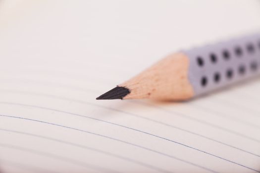 Macro view of pencil on a blank sheet