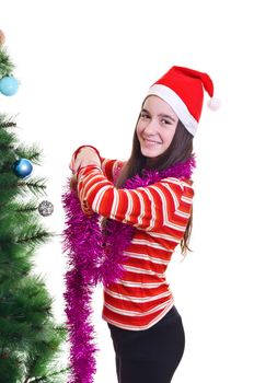 portrait of young girl wearing beanie, standing near christmas tree, eye contact, vertical shot 