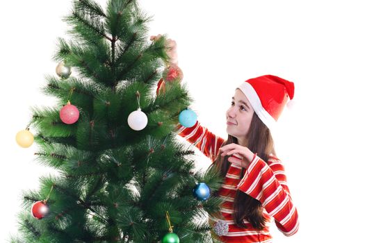 portrait of young girl decorating christmas tree, wearing red cap, horizontal shot