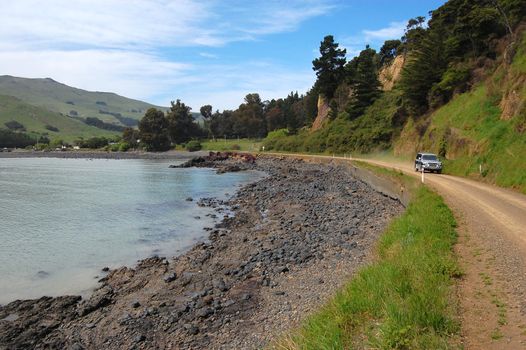 Car driving on gravel road, Banks Peninsula, New Zealand