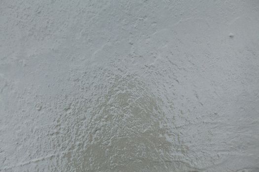 Closeup of a wet concrete. Textured surface