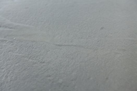 Closeup of a wet concrete. Textured surface