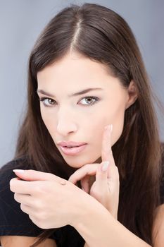 Pretty girl is applying make up with liquid cosmetic powder