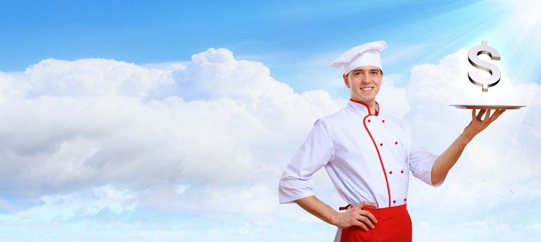 Portrait of a young male cook in red apron against colour background