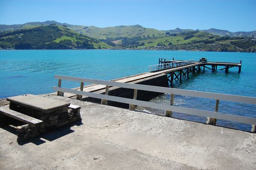Old concrete pier with rails, Banks Peninsula, New Zealand