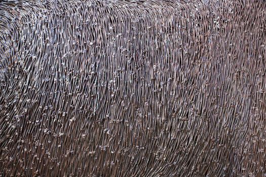 Abstract image of portion of an animal hide composed of welded or brazed nails