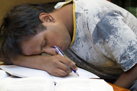 Tired Student asleep at his desk