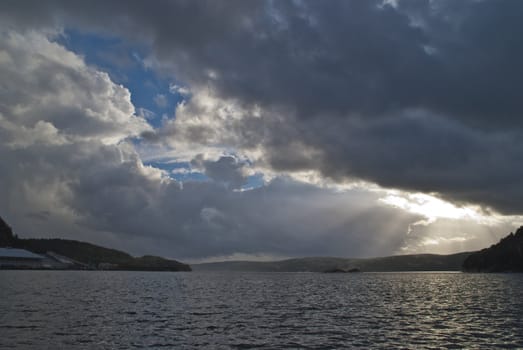 layer of clouds breaking up and the sun trying to break through, then there will be dramatics in the sky, image is shot at halden harbor.