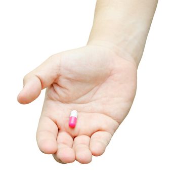 Hand with pill isolated on white background.