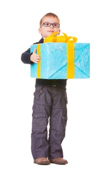 Small boy in spectecles with big present on white background