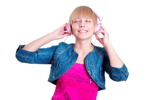 Young attractive woman listing to music with headphones against white background