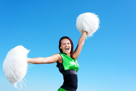 cheerleader girl on a background of blue sky