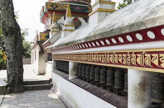 prayer wheels in row in kathmandu, nepal, asia