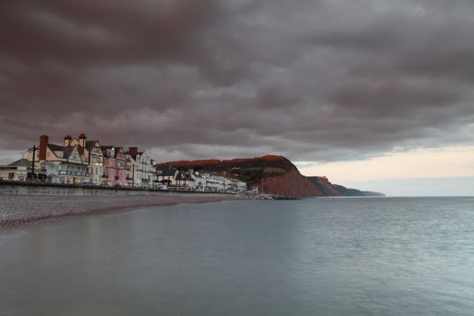 Sidmouth beach as clouds come over the cliffs