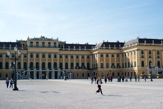 VIENNA - OCTOBER 4: Visitors approaching the Schoenbrunn Palace, a UNESCO World Heritage Site on October 4, 2012 in Vienna, Austria. The Schoenbrunn Palace was built between 1638 and 1643 and is now one of the major tourist attractions in Vienna.