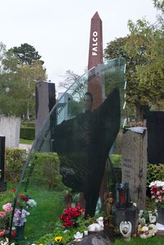 VIENNA - OCTOBER 7: Memorial at Falco’s grave in Zentralfriedhof (Central Cemetery) on October 7, 2012 in Vienna, Austria. Falco was an Austrian pop singer, rapper and musician. His hit single “Rock me Amadeus” was the first and so far only song in German language that ever hit the US Billboard charts. Falco died 1998 in the Dominican Republic and was buried in his home town Vienna, where still many fans pay their respect by visiting his grave every day.
